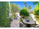 Charming courtyard with stone pavers, an outdoor dining area, and a vintage bicycle at 5101 N Casa Blanca Dr # 25, Paradise Valley, AZ 85253