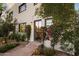 Charming two-story exterior with lush vines, dark trim windows, stone walkway, and colorful bougainvillea at 5101 N Casa Blanca Dr # 25, Paradise Valley, AZ 85253