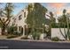 Striking two-story home with abundant greenery, manicured landscaping, stone pathway, and dark trim windows at 5101 N Casa Blanca Dr # 25, Paradise Valley, AZ 85253