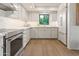 Modern kitchen with white cabinets, stainless steel appliances, and hardwood flooring at 5101 N Casa Blanca Dr # 25, Paradise Valley, AZ 85253