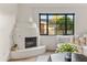 Cozy living room highlighting a unique corner fireplace and natural light from the window at 5101 N Casa Blanca Dr # 25, Paradise Valley, AZ 85253