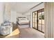 Beautiful main bedroom with hardwood floors, a king bed and doors to an outdoor patio at 5101 N Casa Blanca Dr # 25, Paradise Valley, AZ 85253
