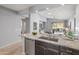 Kitchen island featuring granite countertops, stainless steel appliances, and an open view to the living room at 538 E Pasaro Dr, Phoenix, AZ 85085