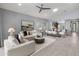 Open-concept living space featuring neutral tones, a modern ceiling fan, and seamless flow into the dining area at 538 E Pasaro Dr, Phoenix, AZ 85085