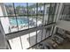 View of the building exterior, swimming pool, and lounge chairs from the interior at 6587 N Palmeraie Blvd # 2041, Paradise Valley, AZ 85253