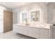Luxurious bathroom with double vanity, lighted mirrors, and marble accents on the walls at 6587 N Palmeraie Blvd # 2041, Paradise Valley, AZ 85253