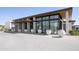 Contemporary building exterior with a flat roof, large windows, and potted floral arrangements at 6587 N Palmeraie Blvd # 2041, Paradise Valley, AZ 85253