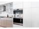 Modern kitchen with stainless steel appliances, white cabinetry, and a geometric tile backsplash at 6587 N Palmeraie Blvd # 2041, Paradise Valley, AZ 85253