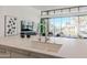 Modern kitchen with a marble island, stainless steel faucet, and a view to the outside at 6587 N Palmeraie Blvd # 2041, Paradise Valley, AZ 85253