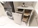 This laundry room has custom pull out storage solutions and a stackable washer dryer at 6587 N Palmeraie Blvd # 2041, Paradise Valley, AZ 85253