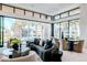 Cozy living room featuring modern decor and large windows overlooking palm trees at 6587 N Palmeraie Blvd # 2041, Paradise Valley, AZ 85253