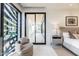 Bright main bedroom with a sitting area, sliding doors, and sleek marble floors at 6587 N Palmeraie Blvd # 2041, Paradise Valley, AZ 85253