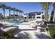 Inviting pool area with lounge chairs and palm trees at The Ritz-Carlton Residences, Paradise Valley at 6587 N Palmeraie Blvd # 2041, Paradise Valley, AZ 85253