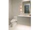 Modern powder room with marble-patterned walls, floating vanity, stylish mirror, and contemporary fixtures at 6587 N Palmeraie Blvd # 2041, Paradise Valley, AZ 85253