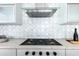 Modern kitchen with a Wolf range and glass range hood at 6587 N Palmeraie Blvd # 2041, Paradise Valley, AZ 85253
