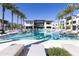 Exterior view of a modern building and an outdoor pool with lounge chairs and palm trees at 6587 N Palmeraie Blvd # 2041, Paradise Valley, AZ 85253