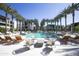 Outdoor swimming pool with lounge chairs, palm trees, and modern architecture at 6587 N Palmeraie Blvd # 2041, Paradise Valley, AZ 85253
