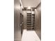 Well-organized walk-in closet with custom wood shelving and drawers for ample storage at 6587 N Palmeraie Blvd # 2041, Paradise Valley, AZ 85253