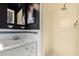 Classic bathroom featuring a white vanity, decorative mirror, and a shower with beige tiled walls at 7327 N 21St Ave, Phoenix, AZ 85021