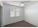 Bedroom with a ceiling fan and window covered with sheer curtains, complemented by neutral carpeting at 7327 N 21St Ave, Phoenix, AZ 85021