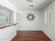 Bright dining area featuring wood floors, a decorative wall mirror, and a pass-through to the kitchen at 7327 N 21St Ave, Phoenix, AZ 85021