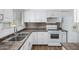 Efficient kitchen featuring white cabinetry, stainless steel appliances, and laminate countertops at 7327 N 21St Ave, Phoenix, AZ 85021