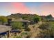 Expansive aerial view showcasing the house and its location nestled in the desert landscape against a mountainous backdrop at 7435 E Quien Sabe Way, Scottsdale, AZ 85266