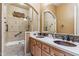 Bathroom boasts double sinks, quartz countertops, and a stunning tile shower and tub at 7435 E Quien Sabe Way, Scottsdale, AZ 85266