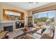 Cozy Gathering room with a fireplace, built-ins, and views of the natural landscape at 7435 E Quien Sabe Way, Scottsdale, AZ 85266