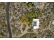 Aerial view of the desert home featuring a backyard pool and desert landscaping at 7451 E Long Rifle Rd, Carefree, AZ 85377