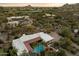 Overhead view of estate with pool and lush desert landscape with mountain views in distance at 7451 E Long Rifle Rd, Carefree, AZ 85377