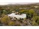 Desert home with white tile roof features a backyard pool and covered patio at 7451 E Long Rifle Rd, Carefree, AZ 85377