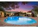 Stunning backyard pool area with a unique fireplace, desert landscaping, and plenty of space for outdoor entertaining at 7451 E Long Rifle Rd, Carefree, AZ 85377
