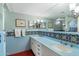 Light blue bathroom features blue tile with and sinks and a large mirror at 7451 E Long Rifle Rd, Carefree, AZ 85377