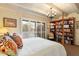 Bedroom with a four poster bed, colorful pillows, bookshelf and access to the patio at 7451 E Long Rifle Rd, Carefree, AZ 85377
