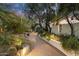 Picturesque gravel walkway lined with desert flora and ambient lighting leading to the home's inviting entrance at 7451 E Long Rifle Rd, Carefree, AZ 85377