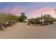 Desert landscaping in front yard, leading to the home with stunning sunset at 7451 E Long Rifle Rd, Carefree, AZ 85377