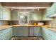 Bright kitchen with stainless steel appliances, light green cabinetry, tile backsplash, and wood countertops at 7451 E Long Rifle Rd, Carefree, AZ 85377