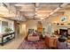 Spacious living room with beamed ceilings, fireplace, terracotta tile, and stylish decor at 7451 E Long Rifle Rd, Carefree, AZ 85377