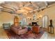 Inviting living room with cozy fireplace, exposed beam ceilings, and comfortable seating at 7451 E Long Rifle Rd, Carefree, AZ 85377