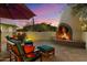 Inviting outdoor fireplace with comfortable seating, perfect for enjoying cool evenings with beautiful views at 7451 E Long Rifle Rd, Carefree, AZ 85377