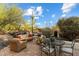 Outdoor patio with a variety of seating options surrounded by native desert plants at 7451 E Long Rifle Rd, Carefree, AZ 85377