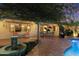 Covered patio area with outdoor seating, fountain, and pool view at 7451 E Long Rifle Rd, Carefree, AZ 85377