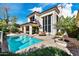 Exterior view of a home and pool, featuring a private pool, patio, and well-manicured landscaping at 7667 E Krall St, Scottsdale, AZ 85250