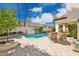 Inviting backyard featuring a pool, lush landscaping, and a stone-paved patio with lounge chairs at 7667 E Krall St, Scottsdale, AZ 85250