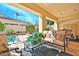 Inviting backyard with a covered patio, outdoor seating, a pool, and lush greenery for relaxing and entertaining at 7667 E Krall St, Scottsdale, AZ 85250
