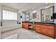 Bathroom with dual sink vanities, glass block window, and tile flooring at 7667 E Krall St, Scottsdale, AZ 85250
