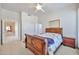 Bright bedroom with a ceiling fan, ensuite bath, and neutral carpet at 7667 E Krall St, Scottsdale, AZ 85250