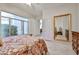 Bedroom with a courtyard view, large mirror, and tile flooring at 7667 E Krall St, Scottsdale, AZ 85250