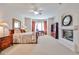 Spacious main bedroom with a fireplace, desk and ceiling fan at 7667 E Krall St, Scottsdale, AZ 85250